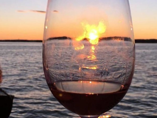 Wine glass with sunset in background