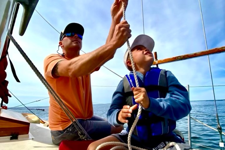 a man riding on the back of a rope